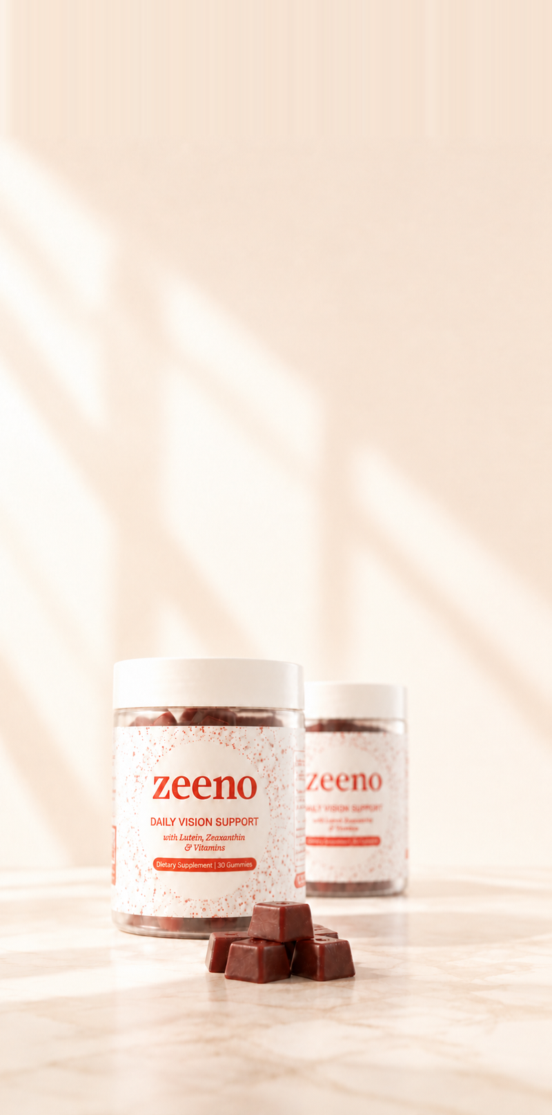 Two jars of Zeeno Daily Vision Support gummies (Zeaxanthin, Lutein, Bilberry and Grapeseed Extract) arranged on a light surface with a few pieces of gummies in front, photographed in warm natural light with soft shadows.